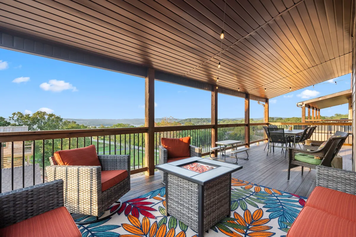 This exterior image features a cozy outdoor seating area with a colorful rug and a fire pit, perfect for evening gatherings. The scene is set during sunset, enhancing the inviting, communal mood—ideal for marshmallow roasting or unwinding after a day of activities.